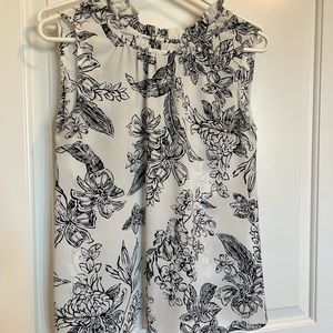Ruffled white and navy blue blouse. Perfect for going into the office.